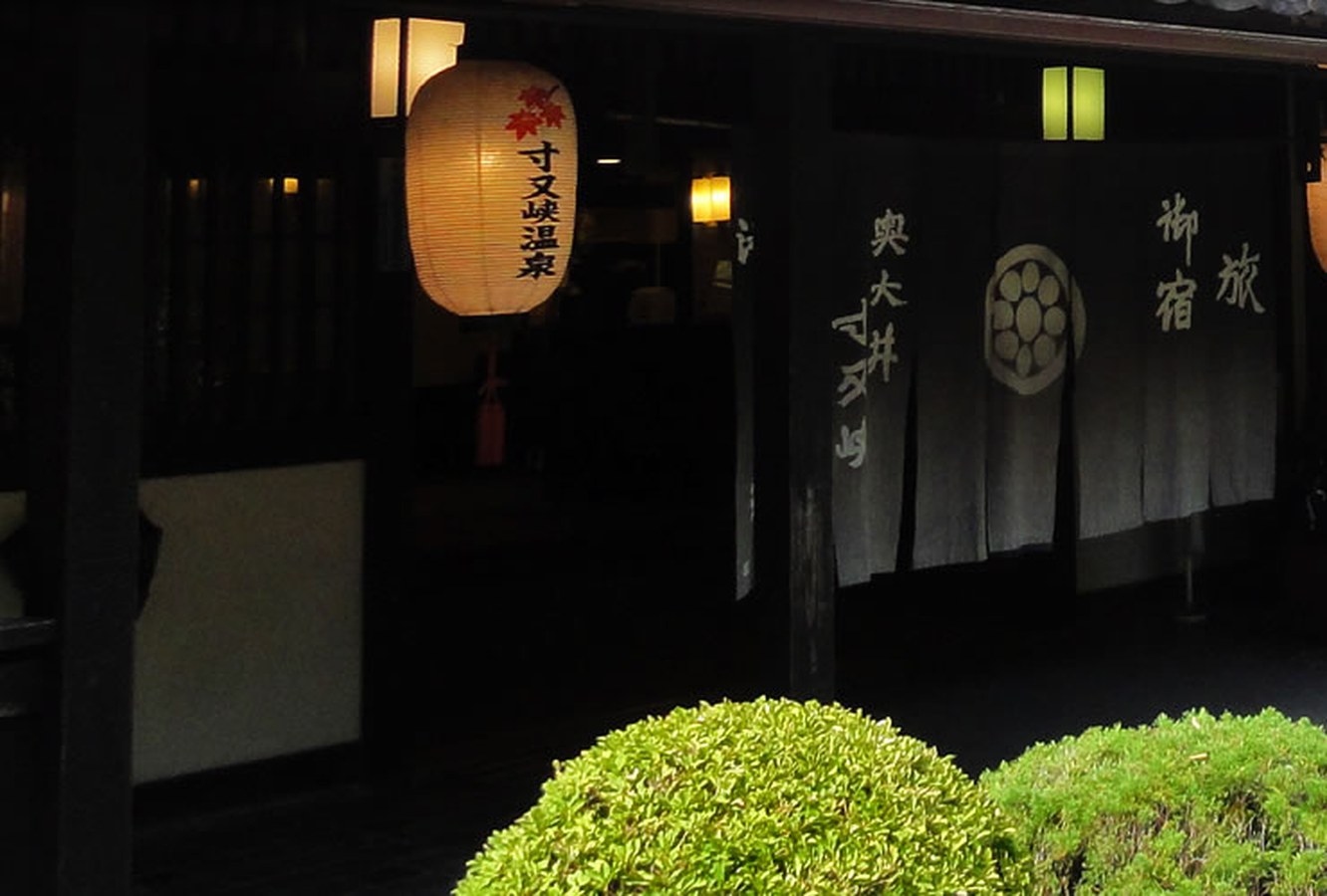 翠紅苑 — 静岡・寸又峡温泉 · 黒板壁と水車を配した木造湯宿の玄関