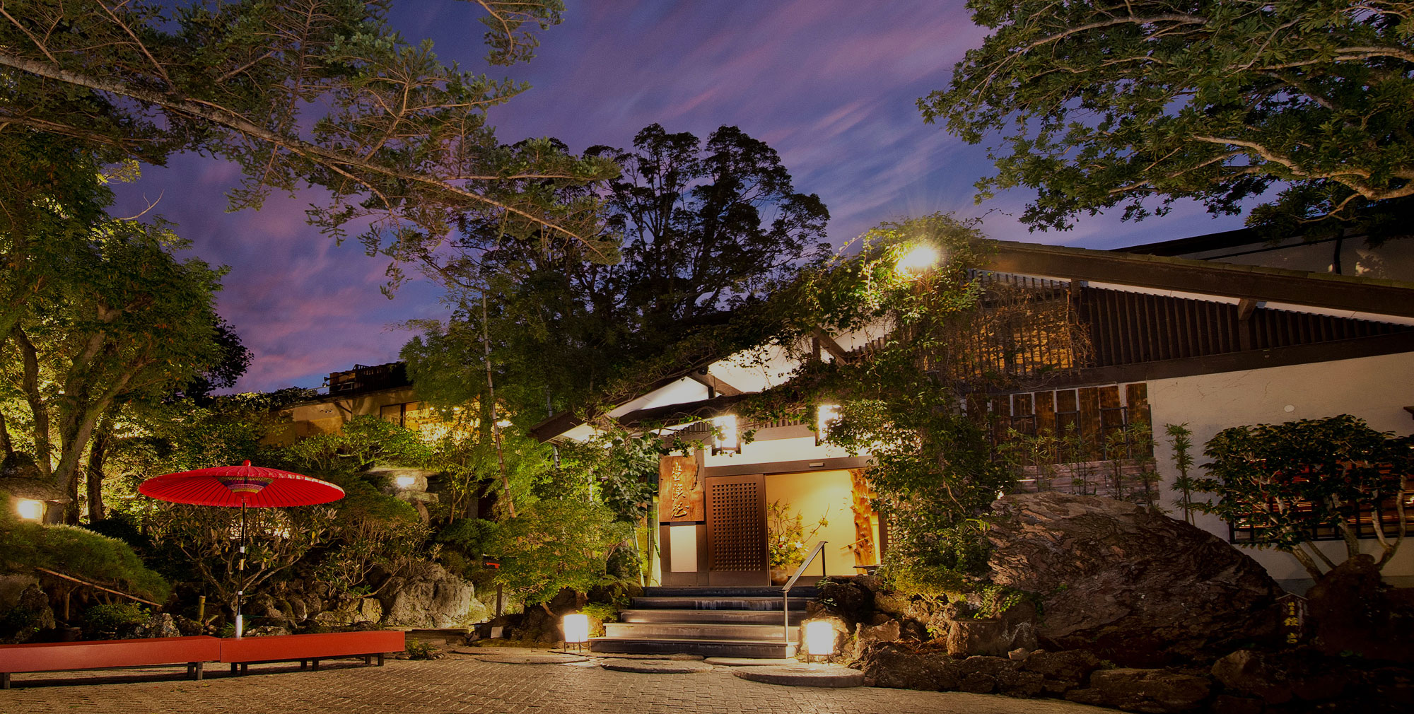 ABBA RESORTS IZU 坐漁荘 — 伊東市八幡野・浮山温泉郷 · 木立に囲まれた玄関まわりの夕景
